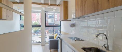 Fridge, microwave, coffee/tea maker, cookware/dishes/utensils
