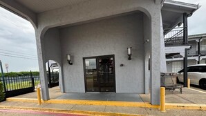 A building entrance with a fire lane and no parking sign. - spanish trails inn (Lancaster)