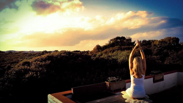A person sitting on a bench with a view of a hillside and a sunset. - TERRACQUA--an oasis of peace in the Tuscan hills (Chiusi)