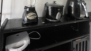 A kitchen counter with a blender, a slow cooker, and a toaster.
