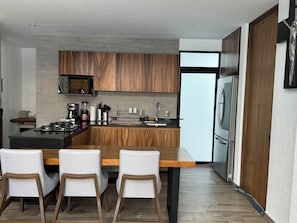 Fridge, microwave, coffee/tea maker, cookware/dishes/utensils