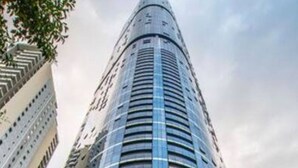 A tall, modern skyscraper with a curved facade and a prominent entrance labeled "222 Brisbane Skytower". - 2BR Luxury Skytower Views CBD Pool Gym Netflix (Brisbane)
