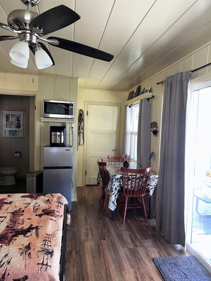 A compact kitchen with a microwave, refrigerator, and ceiling fan. - Tranquil studio with WiFi in sunny outskirts Salinas (Salinas)