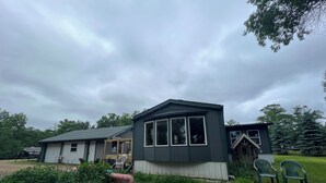 A two-story house with a covered porch and a small attached garage. - Apple River Retreat home in Amery  (Amery)