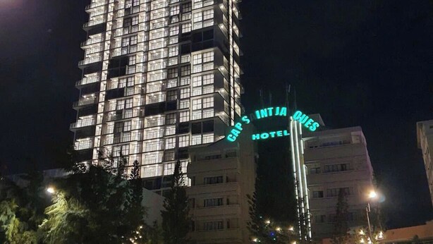 A multi-story hotel with illuminated signage, including "CSJ Tower" and "Gaps Intia Hotel" on the facade. - Beachside Condo CSJ TOWER - Nice View (Ho Chi Minh City)