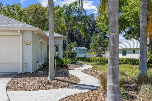 A residential property with a garage, a driveway, and a well-maintained lawn.