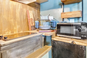 Fridge, microwave, coffee/tea maker, cookware/dishes/utensils