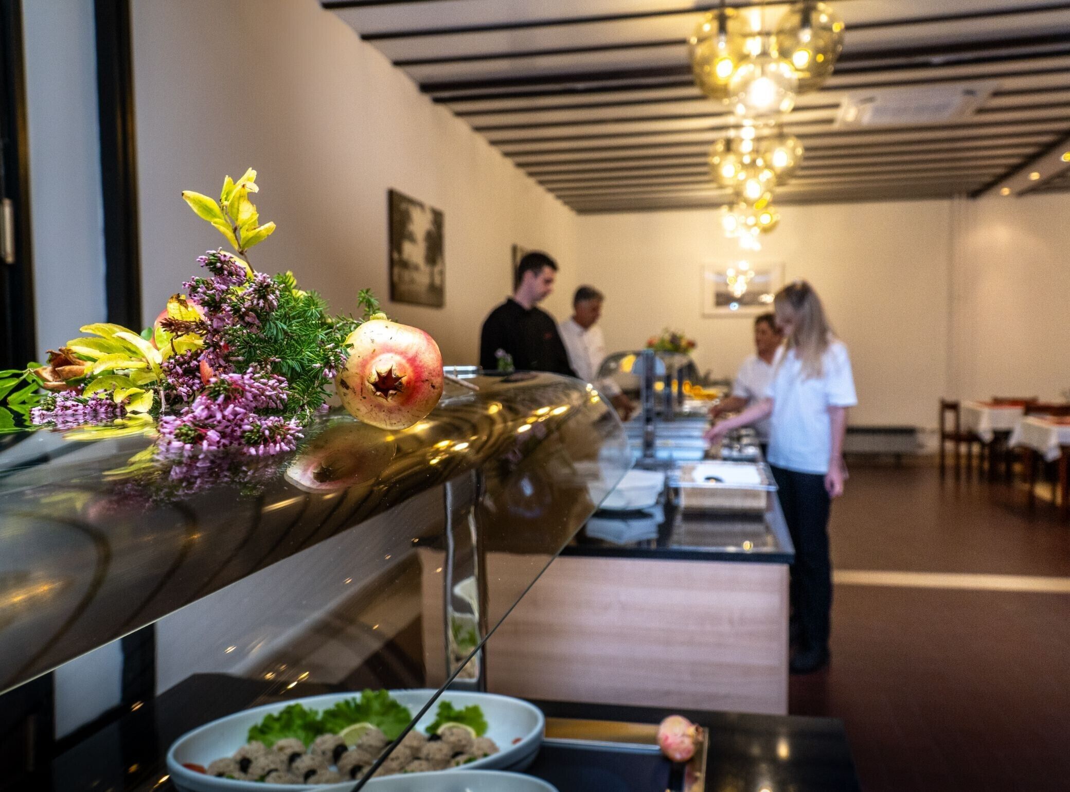 A buffet setup with a variety of food items and decorative elements.