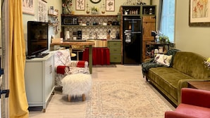 A compact living space with a kitchenette, a dining area, and a seating area. - Romantic Barn I Chickens, Porch, Near City,
Dog Friendly (Hollywood)