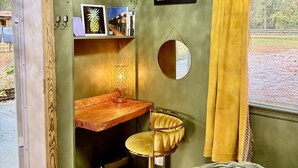 A room with a green wall, a wooden desk, a yellow chair, a mirror, and a window with yellow curtains. - Romantic Barn I Chickens, Porch, Near City,
Dog Friendly (Hollywood)