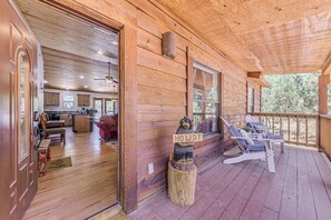 A wooden cabin interior with a porch, a dining area, and a kitchen. - < 2 Mi to Midtown Ruidoso: Forest-View Sanctuary! (Ruidoso)