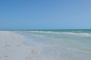 A beach with clear blue water and a sandy shore. - Estero Beach & Tennis 1001-a (Fort Myers Beach)