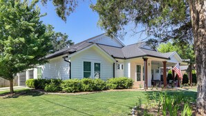 A single-story house with a front porch, a well-maintained lawn, and a small garden area. - West ATL Home w/ Great Outdoor Space: 4 Mi to Dtwn (Atlanta)