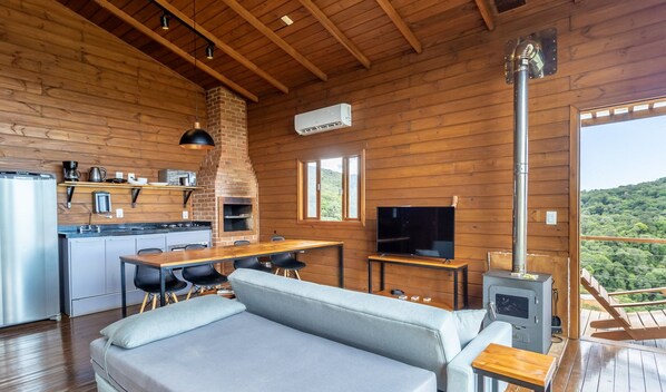 Interior acogedor de una cabaña con cocina, comedor y zona de estar.
