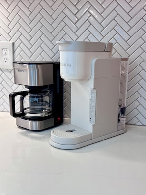 A coffee maker with a Krups brand coffee pot and a Krups brand coffee machine.
