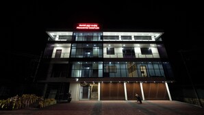 A modern building with a sign reading "PRAKRITHI COMPLEX" at the top. - Golden Crest Residences (Madikeri)