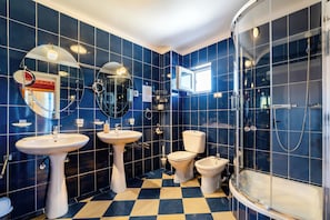 A bathroom with blue tiles, two sinks, a toilet, and a shower. - Plexus By Don Boutique (Eforie)