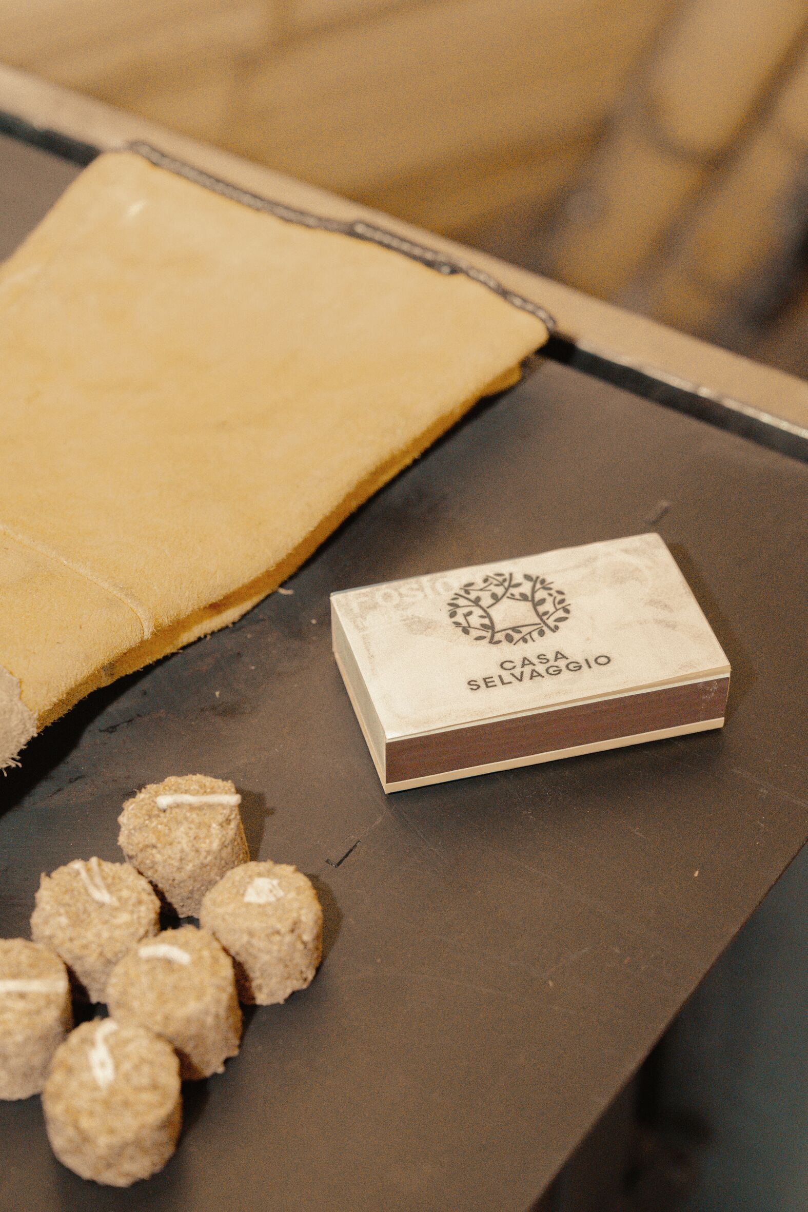 A table with a box labeled "Casa Selvaggio" and several round food items.