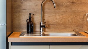 A kitchen with a modern faucet, a soap dispenser, and a stainless steel sink. - Ionian Sol Apartment | Blue Horizon Stay by PikHost (Sarandë)