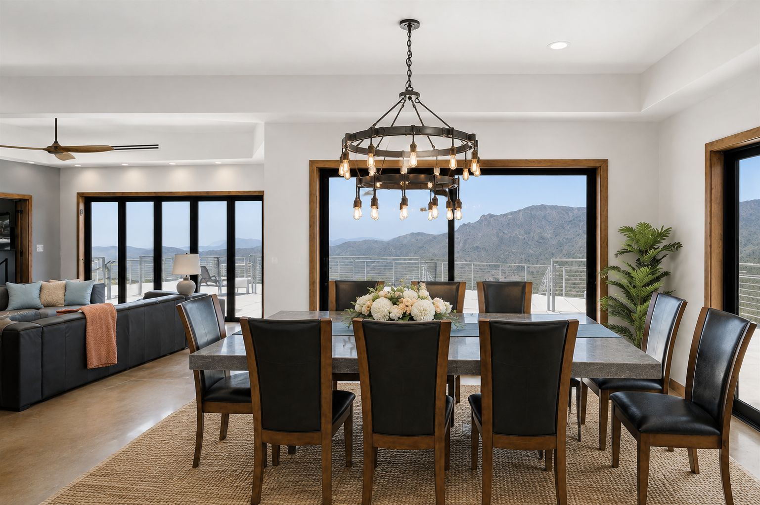 Un comedor con candelabro, un sofá y vistas a la montaña.