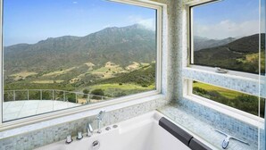 A bathroom with a large window offering a view of a mountainous landscape. - Cloud-Break Ridge | Pool, Spa - Epic Mountain Views (Malibu)