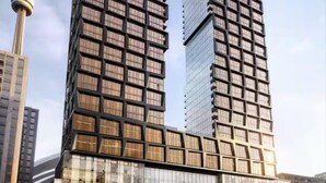 Deux immeubles de grande hauteur, dotés d’une architecture moderne, se distinguent par leurs nombreuses fenêtres et leur façade en verre remarquable.