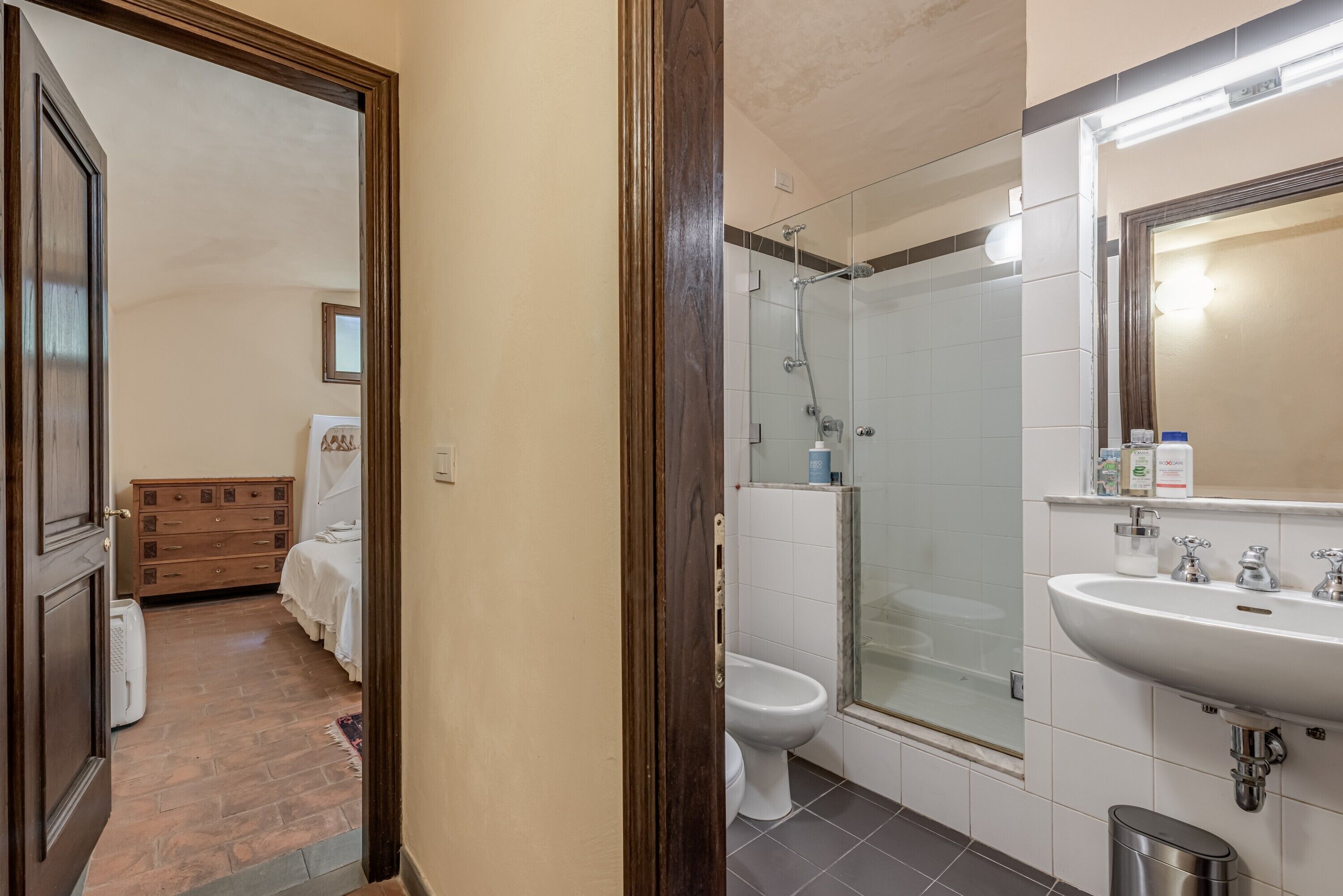A bathroom with a shower, toilet, and sink.