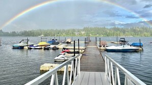 A wooden pier leading to a dock with various boats. - Good Life (lower Suite) @ Shawnigan Beach Resort. (Shawnigan Lake)