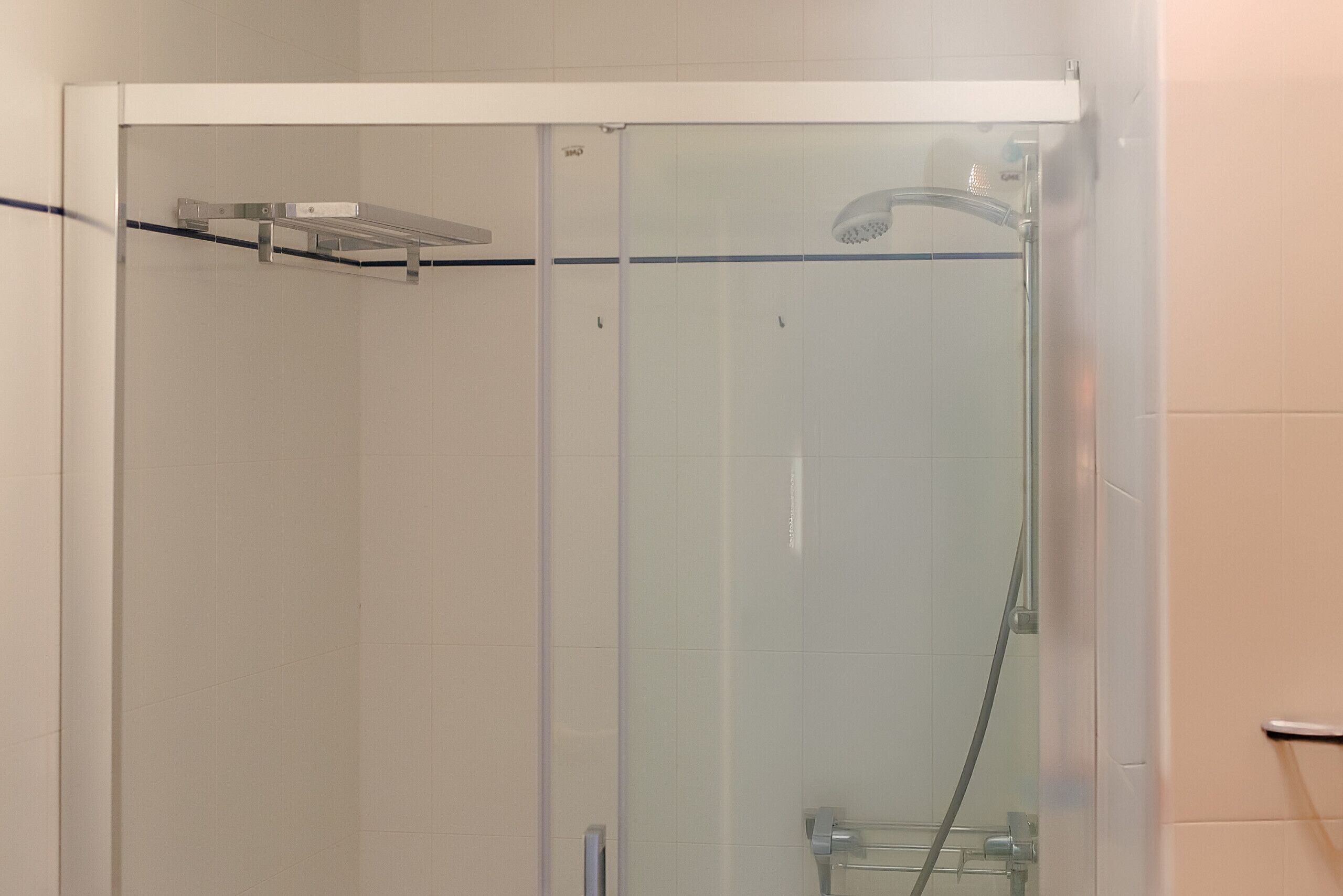 Shower, hair dryer, towels, toilet paper