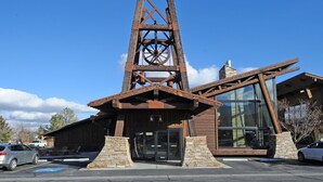 A building with a prominent tower structure and a modern glass extension.