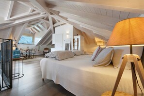 A bedroom with a sloped ceiling, a bed, a lamp, a dresser, and a window. - Apartment 'Brezza' with Lake View, Wi-Fi and Air Conditioning (Bellagio)