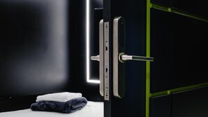 A modern bathroom with a black cabinet, a white countertop, and a towel. - Habitación  Tipo Cápsula (Bogota)