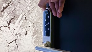 A hand using a numeric keypad on a door lock. - Habitación  Tipo Cápsula (Bogota)