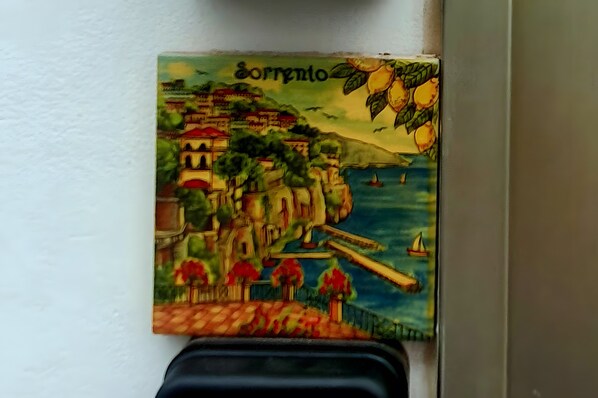 A coastal scene with a town, a bridge, and sailboats.