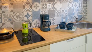 A kitchen with a coffee maker, a kettle, and a tray of cups. - Vacation 'Amalfi' with Wi-Fi (Corralejo)
