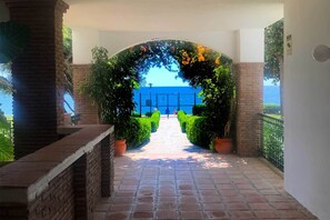 A pathway leading to a gate with a view of the sea.