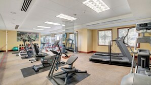 A gym with treadmills, elliptical machines, and free weights. - Desert Oasis Apartment at Viera Resort (Henderson)