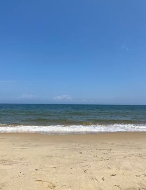 A beach with clear skies and calm waves.