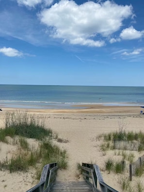 A beach with a wooden boardwalk leading to the water, sandy dunes, and a clear sky. - 5 Min Walk to the Beach • Spacious 3BR/2.5BA Home (Norfolk)