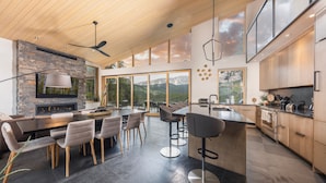 A modern kitchen with a large island, built-in appliances, and large windows offering mountain views. - Spectacular Views, Close to town, Mountain Modern elegance and entertaining! (Blue River)