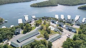 An aerial view of a hotel with multiple buildings, parking areas, and a waterfront.