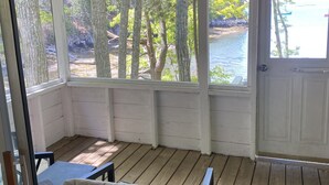 A covered porch with a view of a body of water and trees. - Seaside Cabin Retreat – Breathtaking Views & Ocean Access (Harpswell)