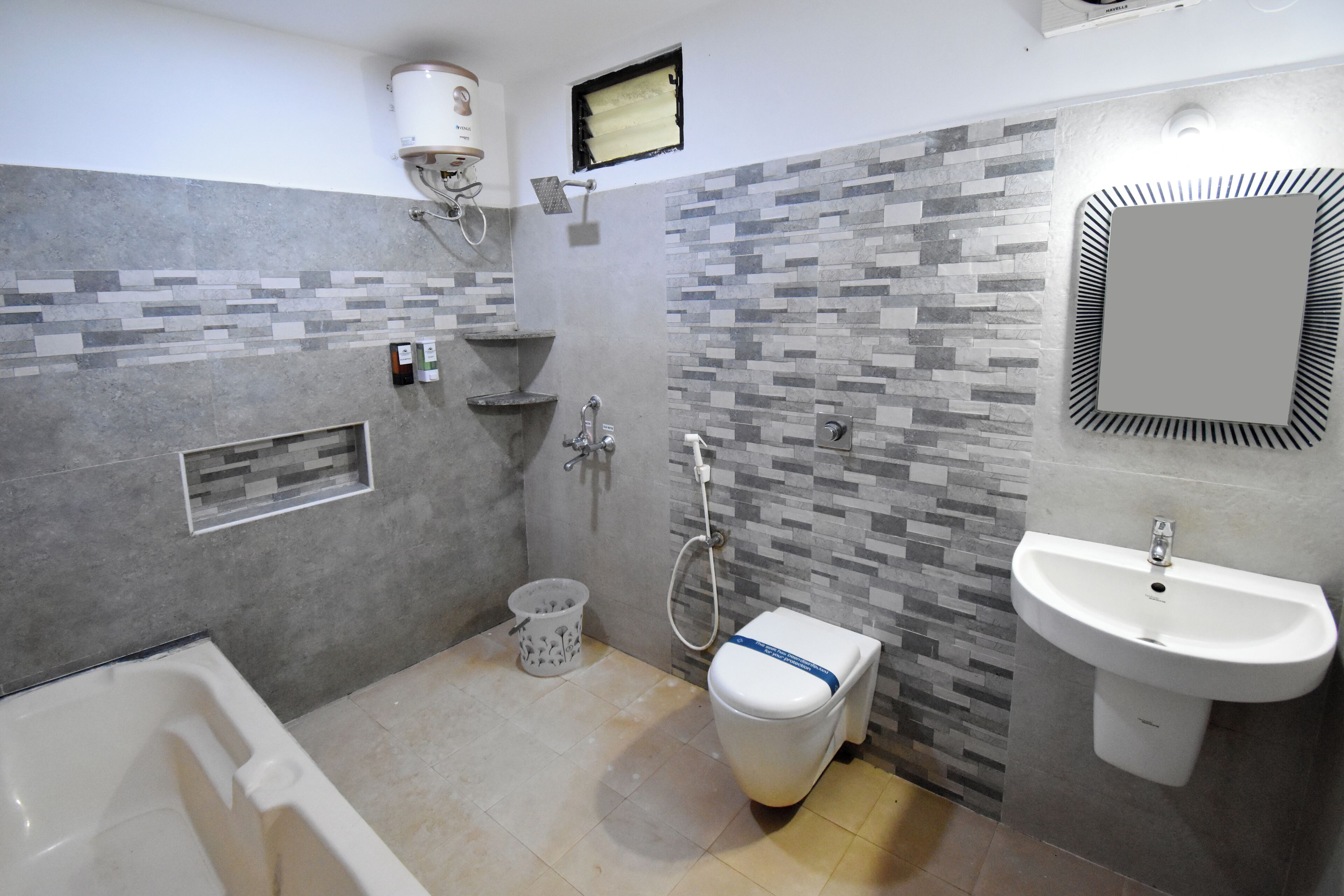 A modern bathroom with a bathtub, toilet, and sink.