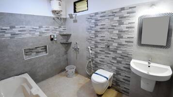 A modern bathroom with a bathtub, toilet, and sink.