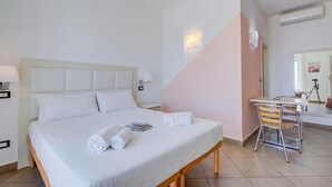 A hotel room with a bed, a desk, and a chair. - Seaview Pool Retreat - M19, Andora, Italy (Andora)
