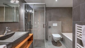 A modern bathroom with a glass-enclosed shower, a wooden vanity, a toilet, and a bathtub. - APARTMENT  LA  CHAPELLE D'ABONDANCE - Oasis B107 (LA CHAPELLE D ABONDANCE)