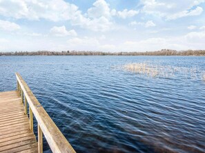 A wooden pier extending into a calm lake with a clear sky above. - 6 Person Holiday Home in Ansager (Ansager)