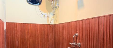 A bathroom with a toilet, a shower, and a sink.
