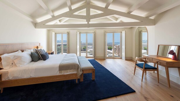 A bedroom with a large bed, a desk, and a view of the sea through large windows. - Oceanfront Villa, Near Porto Historical Centre (Porto)