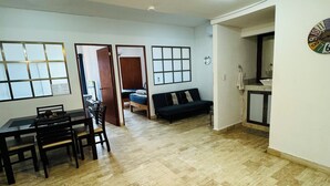 A spacious living area with a dining table, a sofa, and a kitchen area. - Supreme Cancun Hotel Zone #72 right in the heart of the Cancun Hotel Zone. (Cancún)